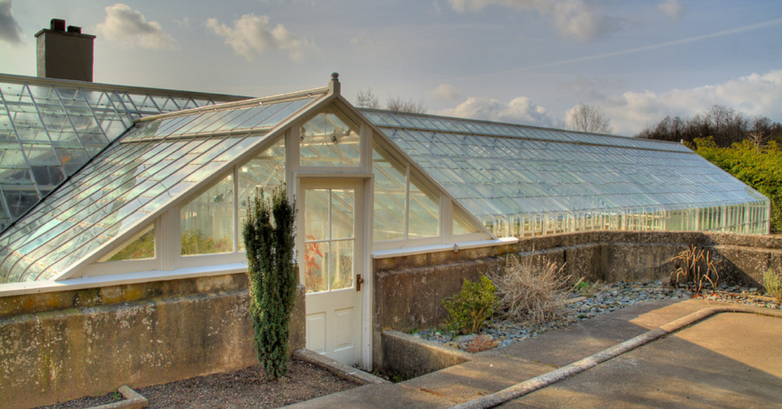 A glass house can be seen on a sunny day.